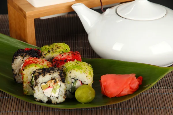 Tasty Maki sushi - Roll on green leaf on gray background — Stock Photo, Image