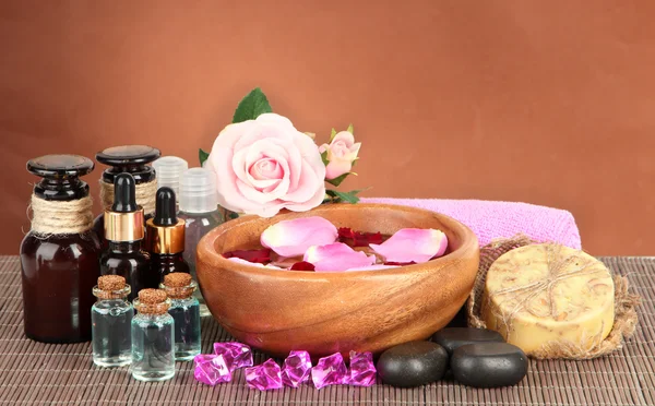 Spa composition with aroma oils on brown background — Stock Photo, Image