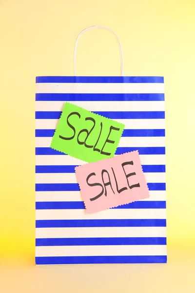 Striped bag on yellow background — Stock Photo, Image