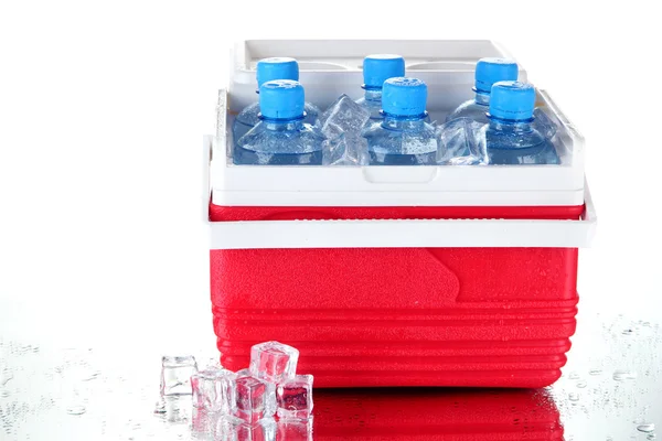 Traveling refrigerator with bottles of water and ice cubes, isolated on white — Stock Photo, Image