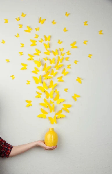 Paper yellow butterflies fly out of vase — Stock Photo, Image