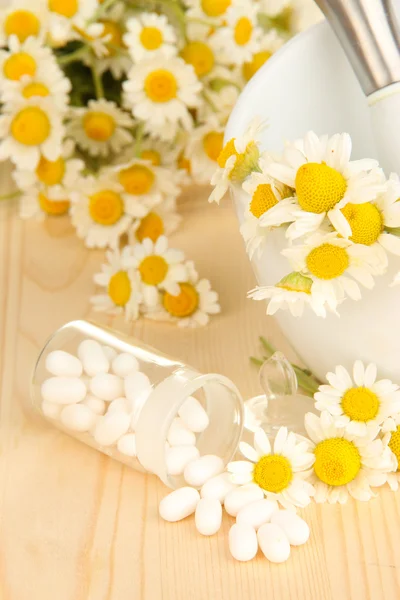 Medicine chamomile flowers on wooden table — Stock Photo, Image