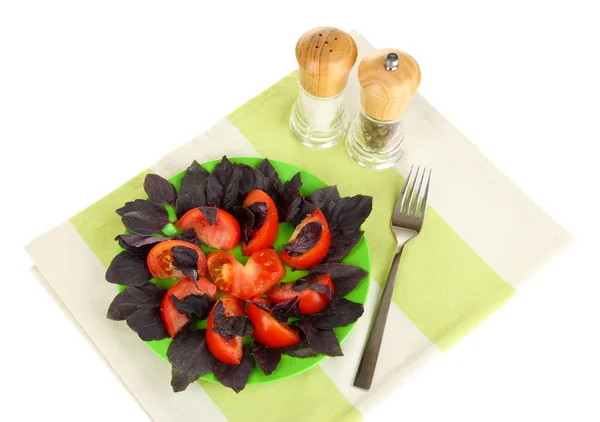 Salad of fresh tomatoes with basil leaves on napkin isolated on white — Stock Photo, Image