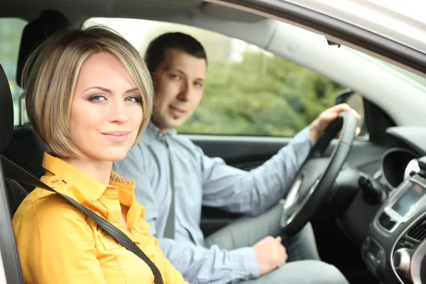 Portrait of young beautiful couple sitting in the car Royalty Free Stock Photos