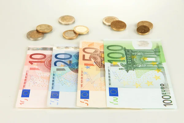 Euro banknotes and euro cents isolated on white — Stock Photo, Image