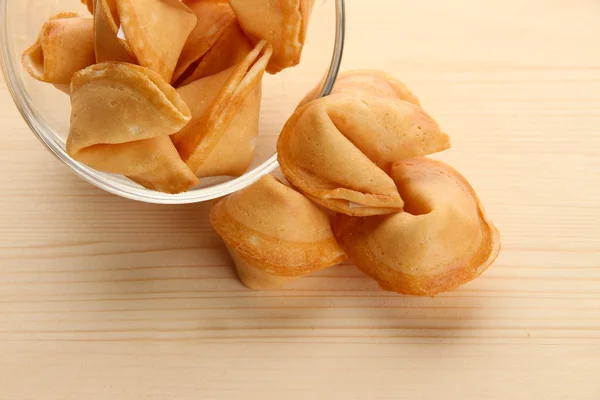 Fortune cookies in bowl, on wooden table — Stock Photo, Image