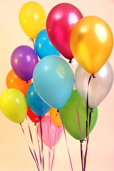 Many bright balloons on orange background — Stock Photo, Image