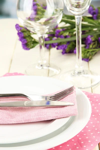 Table serving on a wooden background on the background of the room — Stock Photo, Image