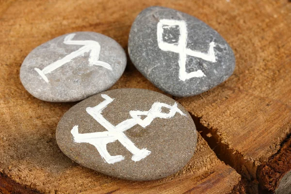 Fortune telling with symbols on stones on wooden background — Stock Photo, Image