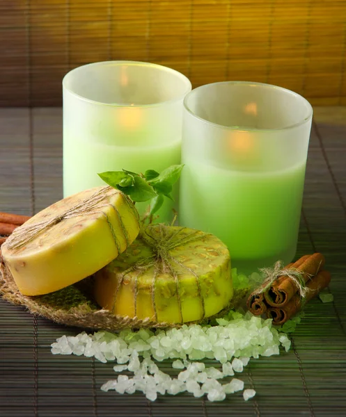 Hand made soap and candles on bamboo mat background — Stock Photo, Image