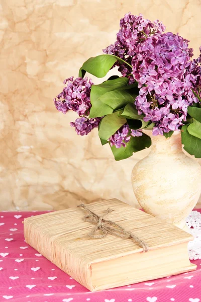 Composition with lilacs on beige background — Stock Photo, Image