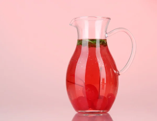 Cherry drink in pitcher on red backgroun — Stock Photo, Image