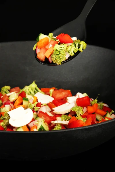 Vegetable ragout in wok, isolated on black — Stock Photo, Image