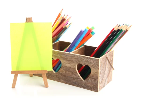 Different pencils in wooden crate and easel, isolated on white — Stock Photo, Image