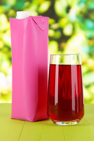 Juice pack on table on bright background — Stock Photo, Image