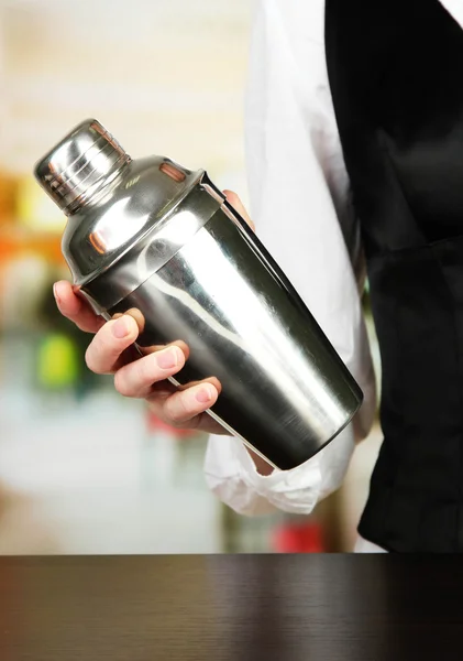 Barmen hand with shaker, on bright background — Stock Photo, Image