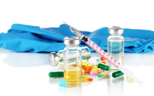 Medical bottles gloves and syringe on gray background — Stock Photo, Image