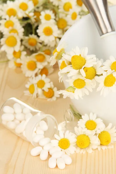 Medicine chamomile flowers on wooden table — Stock Photo, Image