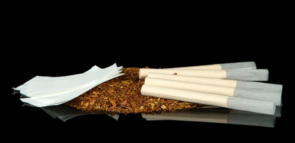 Tobacco and cigarette tubes, isolated on black — Stock Photo, Image