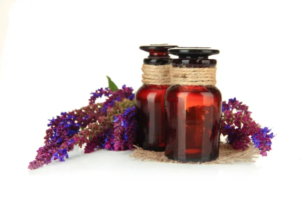 Medicine bottles and salvia flowers, isolated on white — Stock Photo, Image