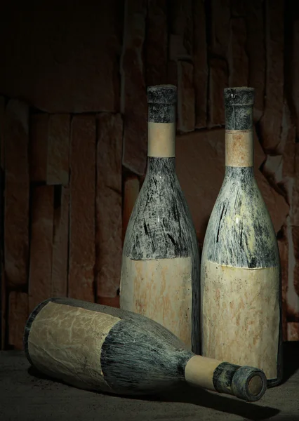 Old bottles of wine in old cellar, on dark background