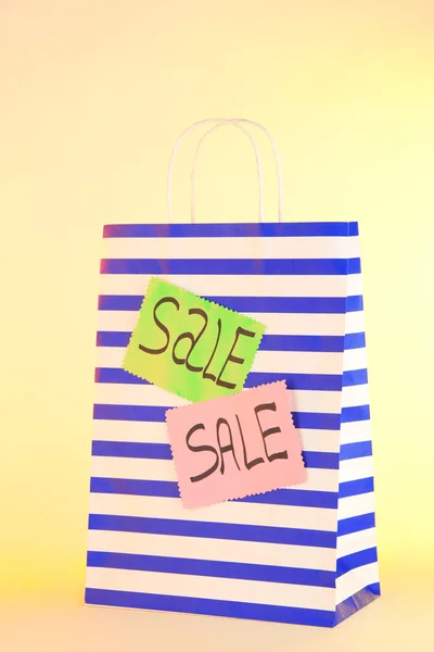 Striped bag on yellow background — Stock Photo, Image