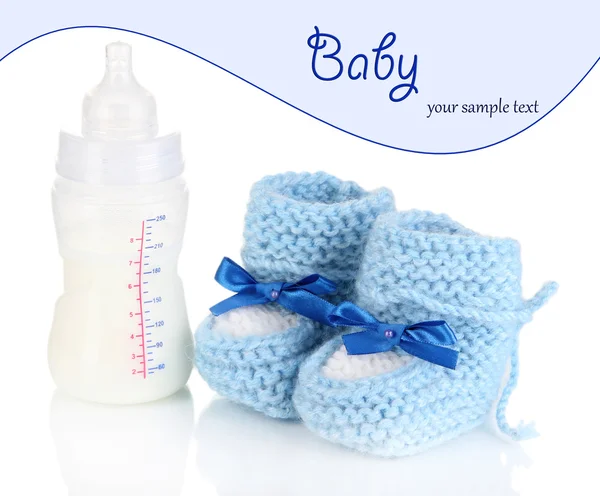 Bottle for milk formula with booties isolated on white — Stock Photo, Image