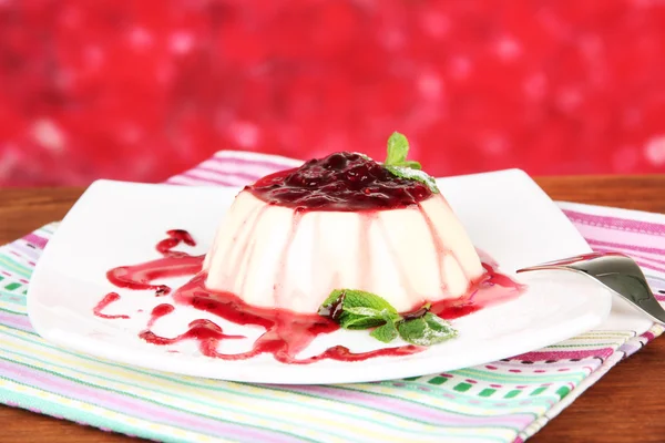 Panna Cotta with raspberry sauce, on bright background — Stock Photo, Image