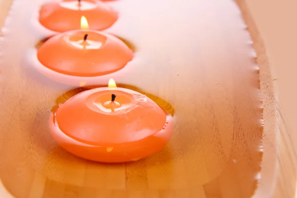 Beautiful candles in water close-up — Stock Photo, Image