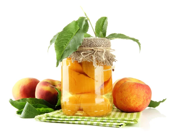 Jar of canned peaches and fresh peaches, isolated on white — Stock Photo, Image