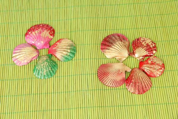 Conchas marinas de colores sobre fondo de bambú estera — Foto de Stock
