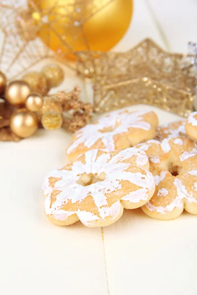 Christmas cookies and decorations on color wooden background — Stock Photo, Image