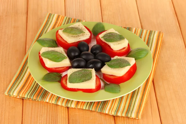 Cheese mozzarella with vegetables in plate on table — Stock Photo, Image