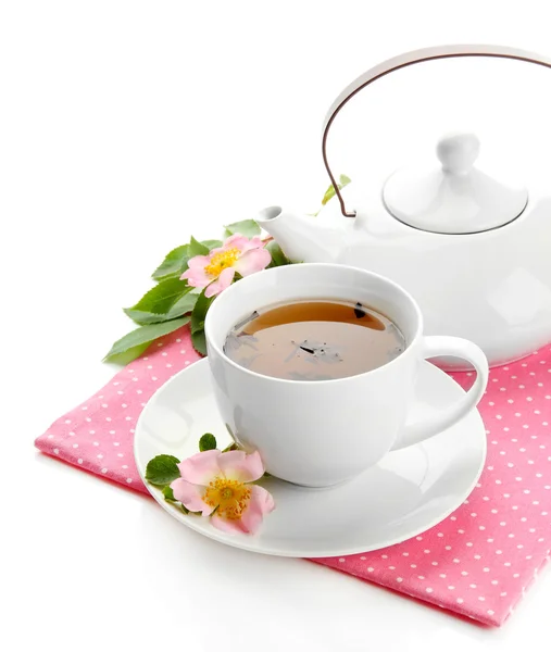 Cup and teapot of herbal tea with hip rose flowers, isolated on white — Stock Photo, Image