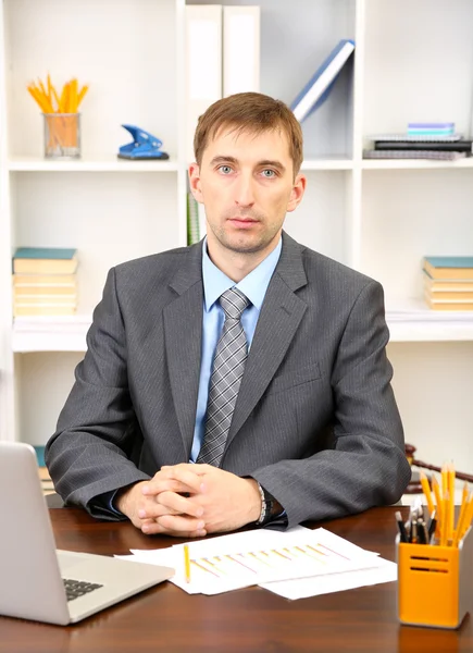 Young businessman in office at his workplace — Stock Photo, Image