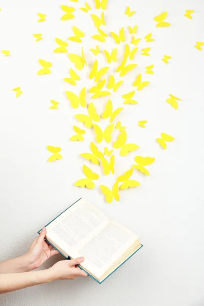 Borboletas amarelas de papel voam fora do livro — Fotografia de Stock