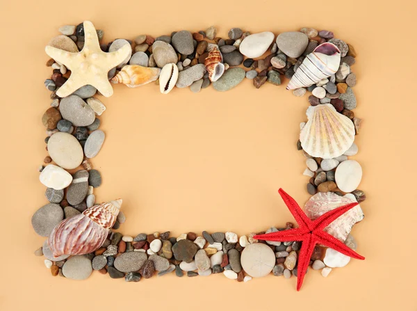 Frame of sea stones on color background — Stock Photo, Image