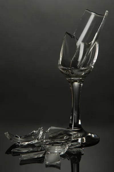 Broken wineglass on grey background — Stock Photo, Image