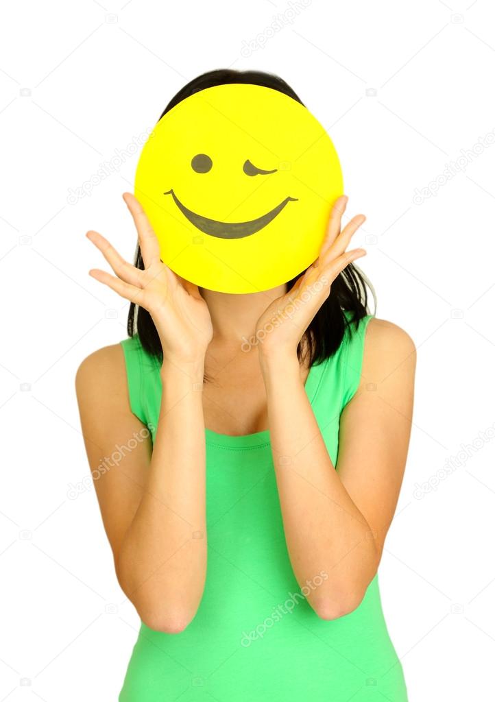 Young woman holding paper with happy smiley on gray background.