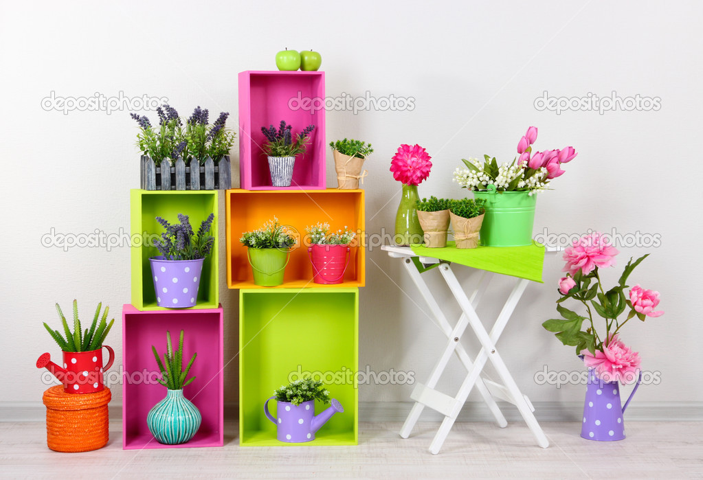Beautiful colorful shelves with decorative elements standing in room