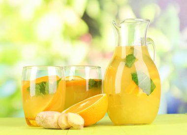 Turuncu limonata sürahi ve gözlük doğal zemin üzerine ahşap tablo