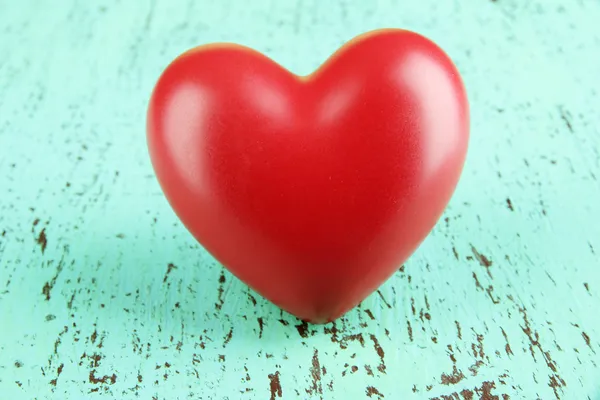 Decorative red heart on color wooden background — ストック写真