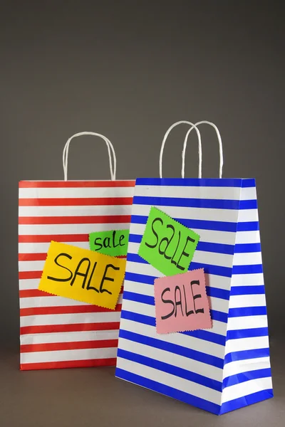 Striped bags on gray background — Stock Photo, Image