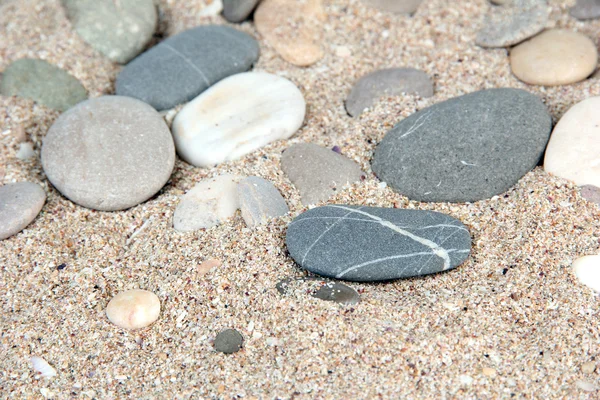 Zee stenen op zand achtergrond — Stockfoto