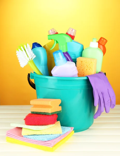 Cleaning items in bucket on color background — Stock Photo, Image