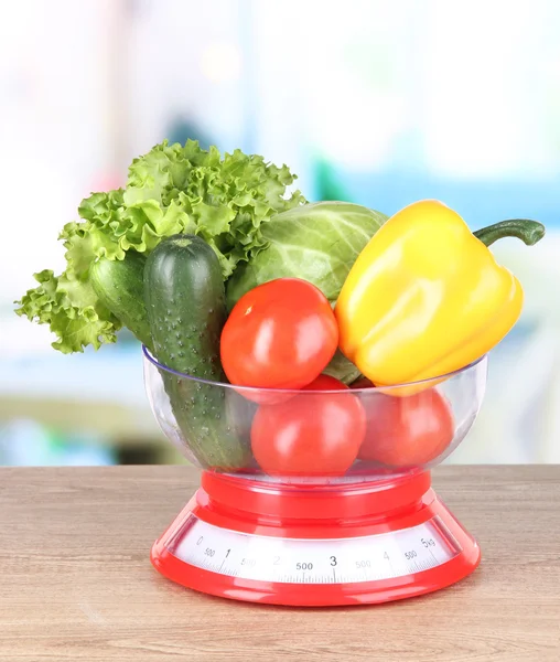 Fresh vegetables in scales on table in kitchen — Stock Photo, Image
