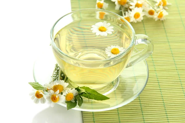Cup of herbal tea with wild camomiles and mint, isolated on white — Stock Photo, Image