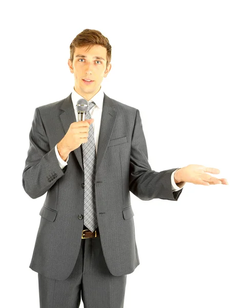 Молодой бизнесмен разговаривает с микрофоном, изолированный на белом — стоковое фото