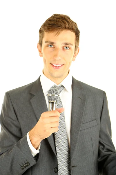 Young businessman talking with microphone, isolated on white — Stock Photo, Image