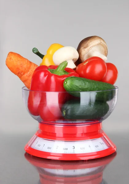 Fresh vegetables in scales on gray background — Stock Photo, Image